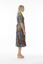 Load image into Gallery viewer, Orientique Zapallar print crinkle short sleeve godet midi dress displayed on a hanger, showcasing vibrant patterns and flowing fabric.