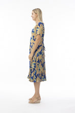 Load image into Gallery viewer, Orientique Playa Brava print crinkle short sleeve godet midi dress displayed on a hanger, showcasing vibrant tropical pattern and flowy design.