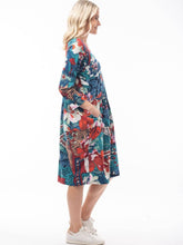 Load image into Gallery viewer, Orientique Apollo blue and red mixed cotton jersey 3/4 sleeve panel bubble dress, side view showing relaxed fit and colorful design.