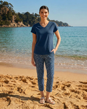 Load image into Gallery viewer, Foil Signature printed 7/8 pull-on trousers in cross indigo fabric, featuring a sleek, fitted design with subtle branding details.
