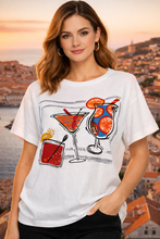 Load image into Gallery viewer, Orientique white Cheers print cotton blend T-shirt with short sleeves and casual fit, featuring a colorful graphic design.