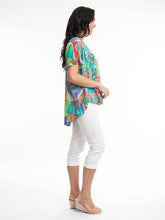 Load image into Gallery viewer, Orientique Zio Turq organic cotton woven top with frill trim and sleeve detail, showcasing lightweight, breathable fabric and stylish design.