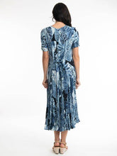 Load image into Gallery viewer, Orientique Agios blue palm print crinkle short sleeve godet midi dress displayed on a hanger showing its flowy design and vibrant pattern.