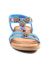 Load image into Gallery viewer, Blue Lunar Feast ribbon and floral trim T-bar open toe sandals with elasticated back, showcasing stylish footwear design.