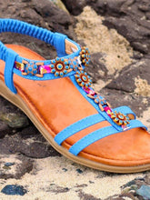 Load image into Gallery viewer, Lunar Feast blue T-bar open toe sandals with floral ribbon trim and elasticated back, stylish and comfortable footwear.