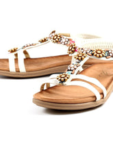 Load image into Gallery viewer, Lunar Feast white T-Bar open toe sandals with floral ribbon trim and elasticated back, stylish summer footwear.