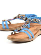 Load image into Gallery viewer, Blue Lunar Feast T-Bar open toe sandals with floral ribbon trim and elasticated back, stylish and comfortable footwear.