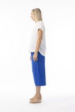 Load image into Gallery viewer, Orientique electric blue loose cotton and linen blend cropped trousers, organic and comfortable for casual wear, shown on model.
