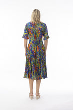 Load image into Gallery viewer, Orientique Zapallar print crinkle short sleeve godet midi dress displayed on a model, showcasing colorful floral pattern and flowing style.
