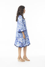 Load image into Gallery viewer, Orientique Okayama printed organic cotton dress with open neck, tassels, and tiered design, perfect for casual summer wear.
