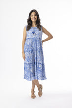 Load image into Gallery viewer, Orientique Aksharay blue sleeveless boho dress with tassels and tiered design, made from printed organic cotton.
