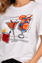Load image into Gallery viewer, Close-up of Orientique white Cheers print cotton blend T-shirt showing colorful graphic design and soft fabric texture.
